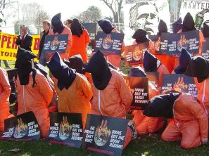 Participants in a rally sponsored by The World Can't Wait are dressed as hooded detainees on January 4, 2007. Photo by Ben Schumin.